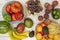 Image of fruits and vegetables in fruit bowls or on the table. Ripe bananas, melons and watermelons, red grapes, nectarines and