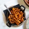 Image of fry pan with fried beef with chorizo on table