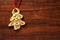 Image of gingerbread Christmas tree cookie over brown wooden tex