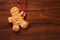 Image of Gingerbread man cookie over brown wooden texture