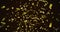 Image of golden confetti floating on black background