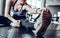 Image of gorgeous young fitness woman sitting in gym near window while make stretching exercises