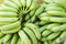 Image of green bananas stacked for sale
