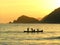 image of group of fishermen in boat at sea in wonderful golden sunset