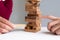 Image of hand holding blocks wood game to growing up of business. Risk of management and strategy plan