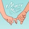 The image of the hands of a young couple with their forefingers clasped with the words ` Marry me`