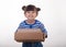 Image of a happy child standing with parcel post box isolated over white background.