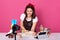 Image of happy woman kneading dough in kitchen in front of tripod with camera, preparing for Easter holiday, baking pie, smiling