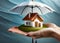 An image of a house in the palm of your hand and an umbrella on it.Visual information about Housing Insurance