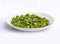 An image isolated close-up selected focus green peas bean on bowl ceramic white the food is a snack salty taste fried crunchy on