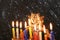 Image of jewish holiday Hanukkah background with menorah (traditional candelabra) Burning candles over black background