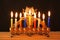 Image of jewish holiday Hanukkah background with menorah (traditional candelabra) Burning candles over black background