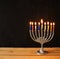 Image of jewish holiday Hanukkah background with menorah (traditional candelabra) Burning candles over black background