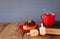 Image of jewish holiday Hanukkah with donuts, wooden spinning top, cup of hot chocolate and old book.