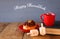 image of jewish holiday Hanukkah with donuts, wooden spinning top, cup of hot chocolate and old book.