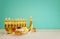 Image of jewish holiday Hanukkah with menorah traditional Candelabra, donut and wooden dreidel spinning top