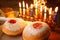 image of jewish holiday Hanukkah with menorah (traditional Candelabra), donuts. retro filtered image with glitter overlay