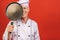 Image of joyful senior chief man in cook uniform smiling and holding frying pan isolated over red wall background