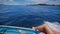 Image of legs of a young woman in marine cruise lying on the deck of sailing boat in open sea. Suntanned bare feet