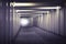 An image of light at the end of a underground concrete tunnel. A long concrete tunnel with lanterns in the city underground.