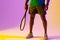 Image of low section of african american male tennis player in violet and yellow neon lighting