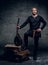 Image of male musicians in old traditional Celtic clothes holds vintage mandolin.