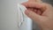 Image with Man Hand Disinfecting a Lights Switch Using a Wet Wipe and Disinfectant Solution