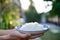 Image of a man holding a plate of white rice cooked Thai Jasmine rice