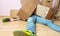 Image of man in jeans lying under cardboard boxes