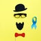 Image of a man on paper. Beard sunglasses hat and blue ribbon. Concept of prostate cancer