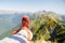 Image of man in red sneakers and picturesque mountainous landscape