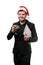 Image of man in Santa`s cap, with caramel cane in mouth, with glass of champagne, folder with blank sheet in hands.