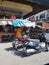 Image of market place where shopkeepers  and vehicles are seen in India