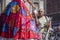 Image of a Mexican taking propaganda of a girl with stilts and typical dress