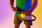 Image of midsection of african american male tennis player in violet and yellow neon lighting