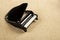 Image of miniature piano sand background