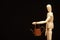 Image of miniature rusty watering can wooden figure dark background