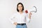 Image of modern asian woman with megaphone, making announcement, white background