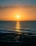 Image of a morning seascape during the late autumn / Sun reflections in a morning scene / Portrait sunrise with high contrast