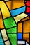 Image of a multicolored stained glass window with irregular bloc