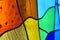 Image of a multicolored stained glass window with irregular bloc