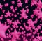 Image of multiple bright pink different sized stars on black background