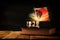 Image of mysterious treasure chest with light and smoke over old book on wooden table.