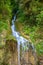 Image of narrow waterfall among grass