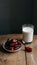 Image Neat arrangement of dates next to a glass of milk on the kitchen table