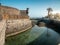 Image of old stone castle with water moat on the ocean coast