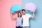 Image of optimistic couple holding copyspace commercial bubbles