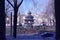 Image of oriental looking structure building in the city park with view of trees and street