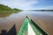 Image in Peruvian jungle of a boat in a river in Amazon forest. Traditional way of transportation in tropical rivers