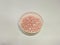 Image of pink pearl imitation beads on white bowl for handmade crafting